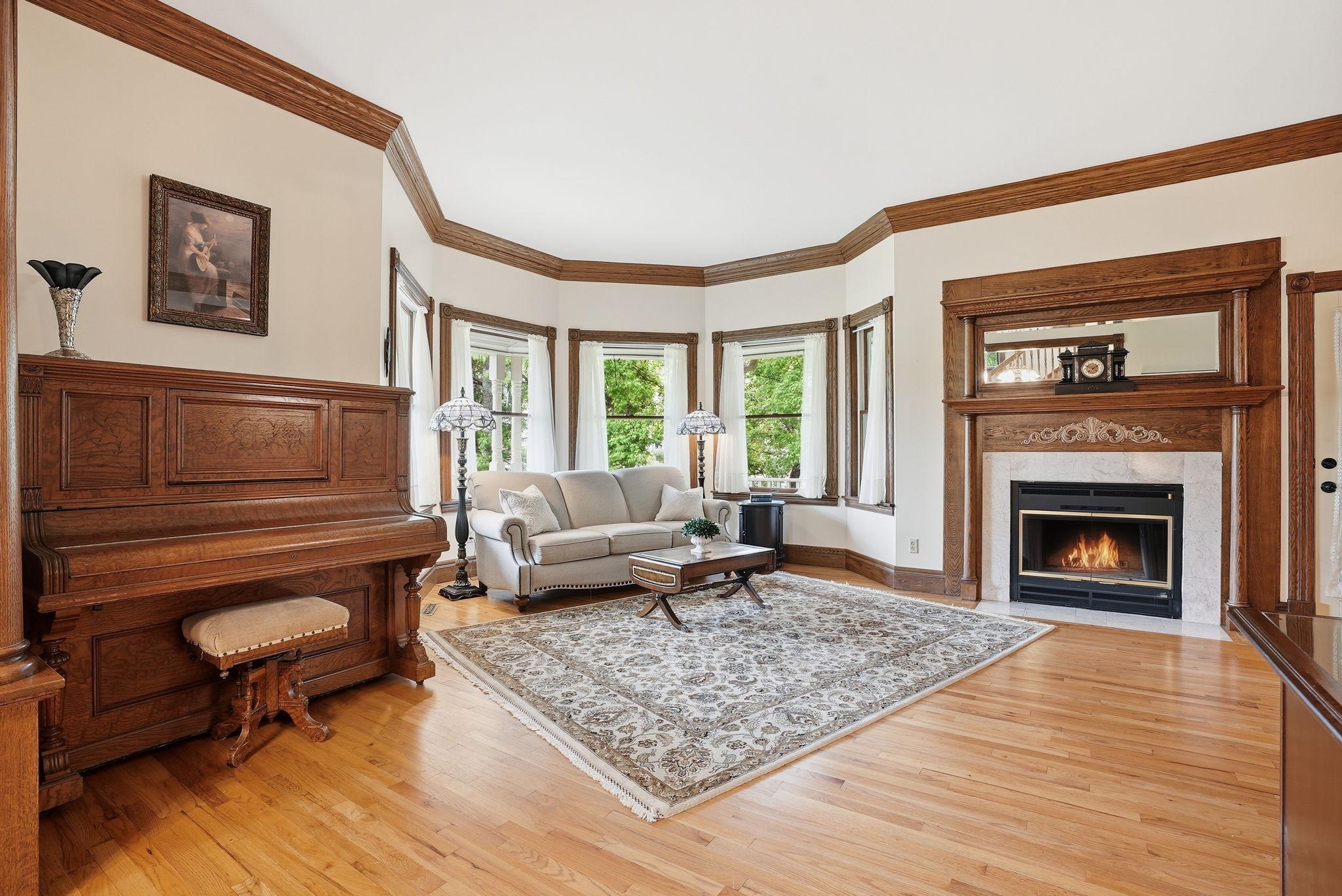 Sun-drenched living room with wood burning fireplace.