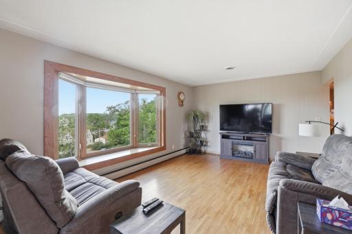 Light & bright living room with bay window overlooking the river