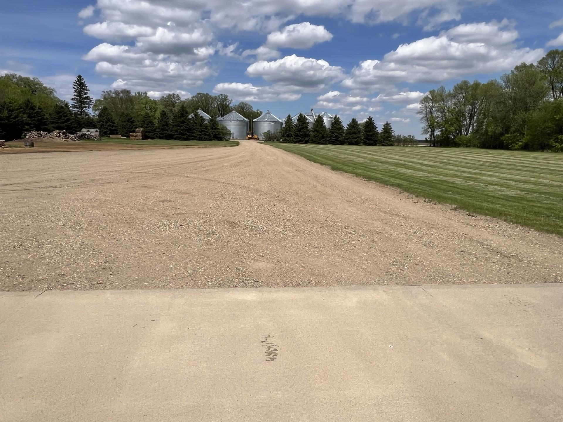 Large gravel driveway with lots of parking lot