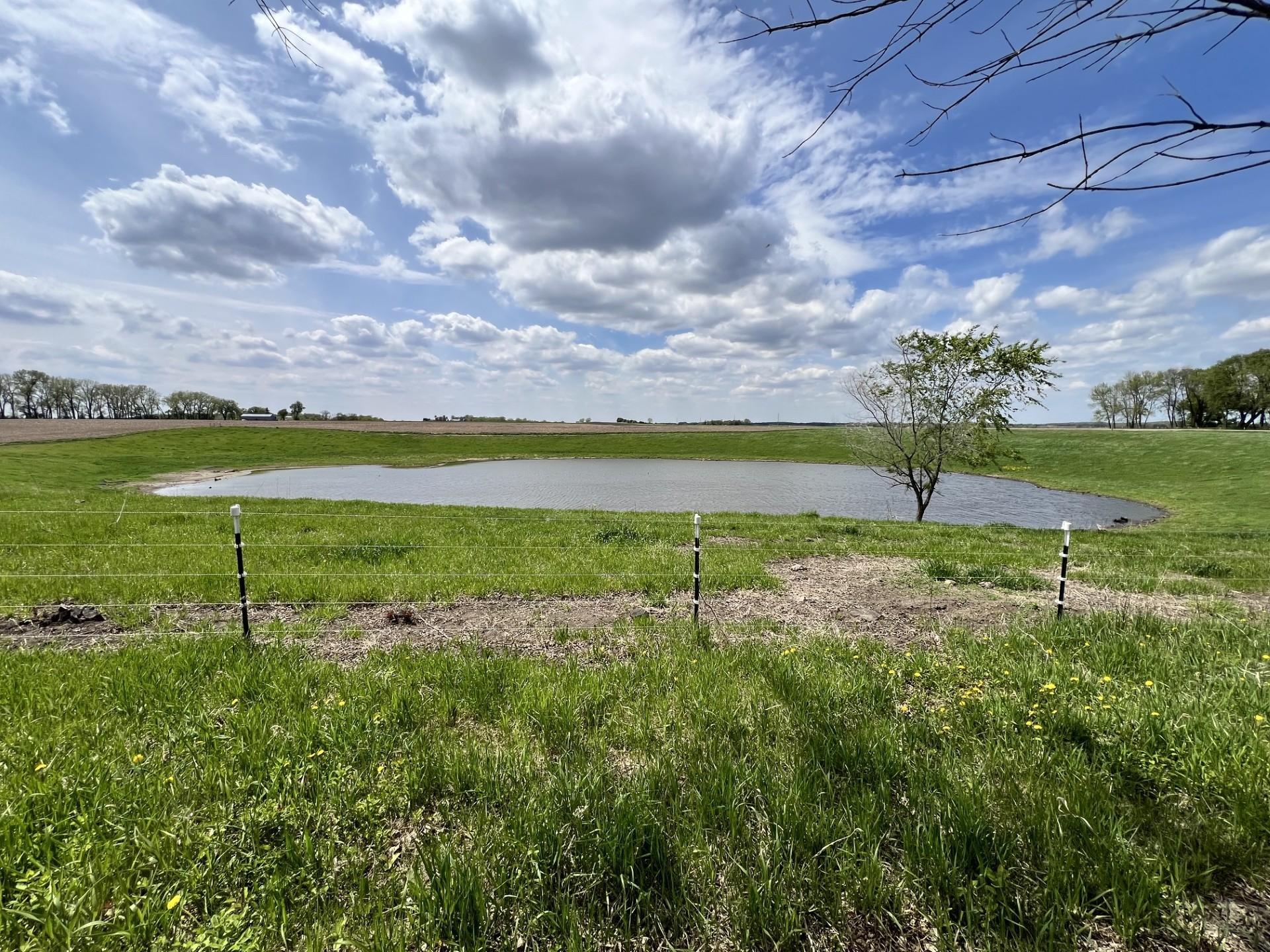 Fenced in pasture land with private pond
