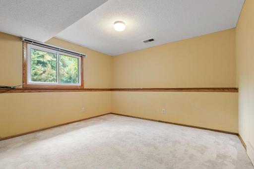 Lower level bedroom - so spacious. You'll love the wooden ledge for added character