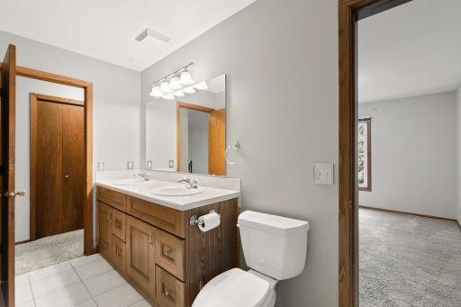 Bathroom leading into the primary bedroom and hallway