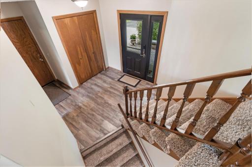 Inviting entryway with updated luxury vinyl flooring and front closet and updated, new front door