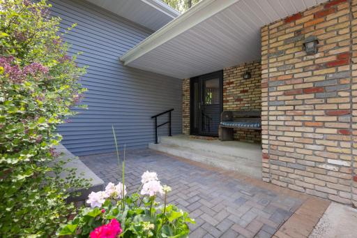 Inviting front patio space...perfect space for a few chairs & table with firepit to have a cup of coffee in the morning or a glass of wine