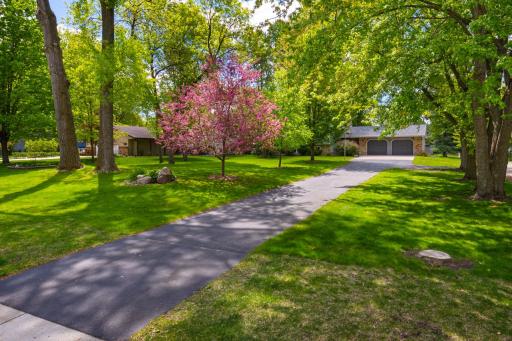 Beautiful setting as the home is set back from the street with beautiful lush yard and mature trees