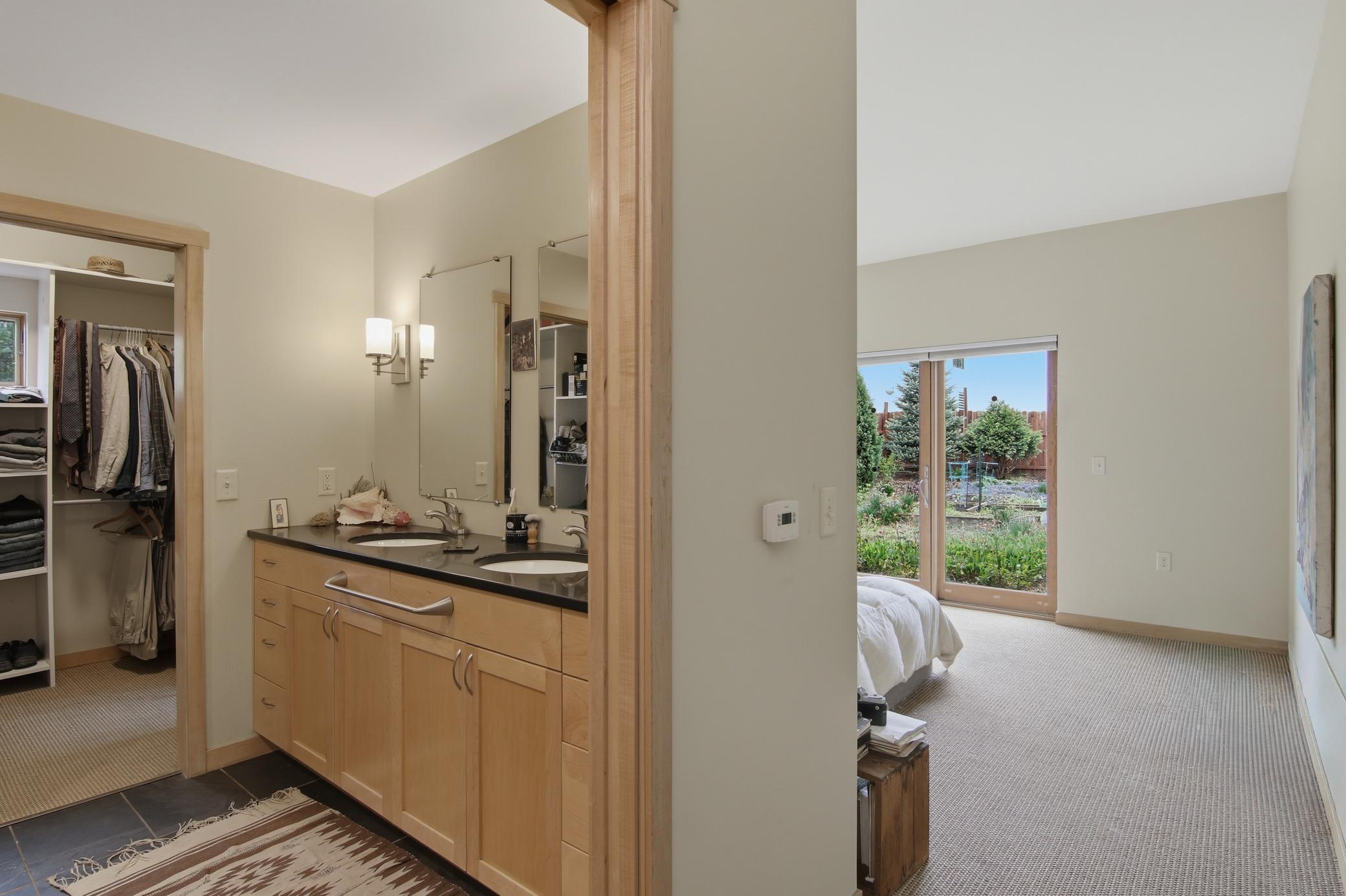 Master bath with double vanity and glass enclosed shower.