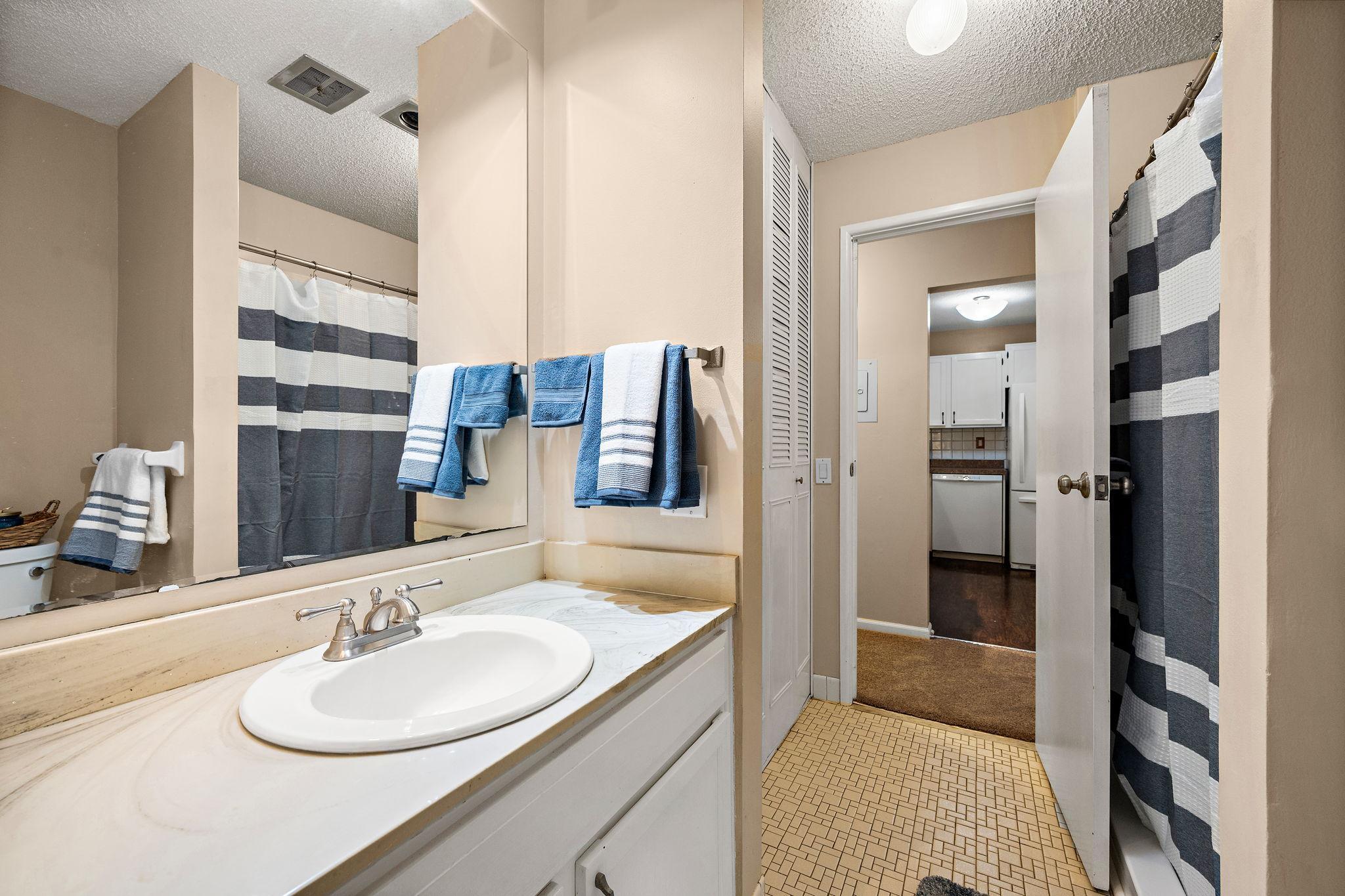 The walk-through bathroom features a large, walk-in shower.