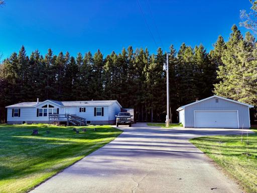 Home with concrete drive and garage