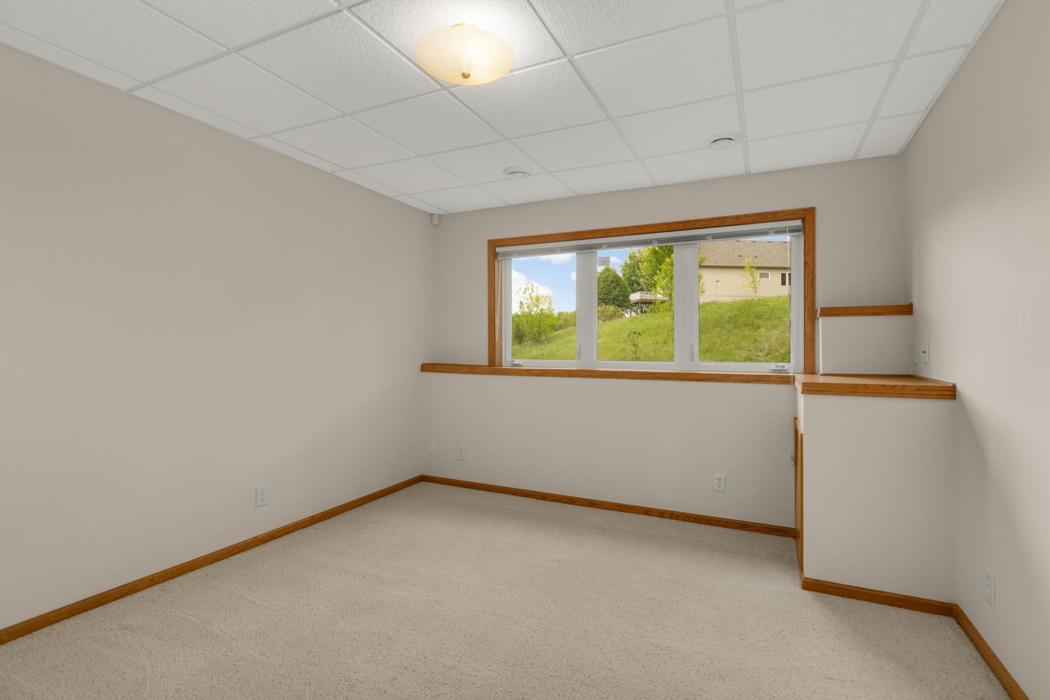 The lower-level third bedroom offers the perfect private space for guests or hobbies