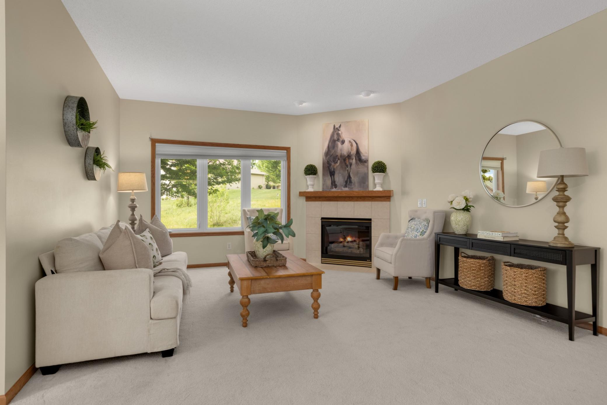 Sunlight fills this bright, open living room through oversized windows