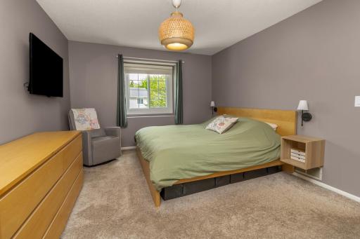 Primary bedroom easily has room for this king sized bed, dresser storage and nightstands!