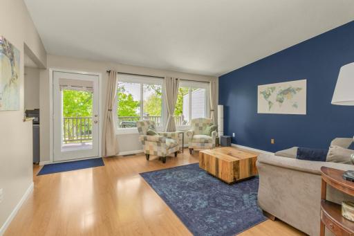 Love these hard surface floors and the open flow to this living room! Deck access just across with tons of light coming thru these newer windows (2024/2025)!!