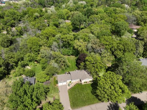 This home is surrounded by mature trees, providing a private oasis.