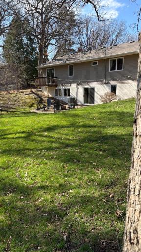 Another view showcasing the wooded backyard. You will enjoy mature red maple, weeping willow, pine and oak trees.