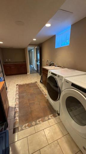 View of laundry room showcasing the storage and folding counter.