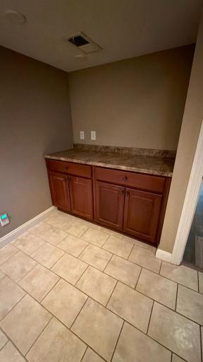 Spacious laundry room with built-it storage and folding counter.