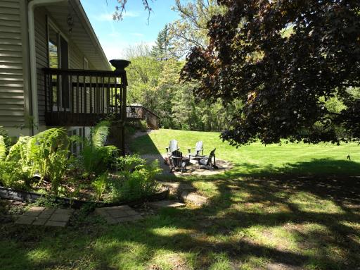 Side view of the backyard and the private primary suite deck.