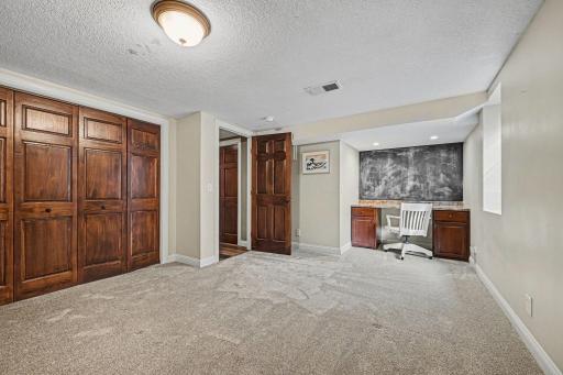 Move-in ready! This bright 4th bedroom boasts newer carpet (2024), modern knockdown ceilings, and a built-in desk. With a large closet and egress window, itâs a quiet, updated retreat. A great addition to this spacious walk-out lower level!