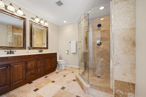 Modern & bright ensuite bath. Boasts a dual comfort-height vanity with ample storage and a stunning glass walk-in shower featuring a tile surround. Ceramic tile floors complete this updated, private primary bathroom. Truly move-in ready!