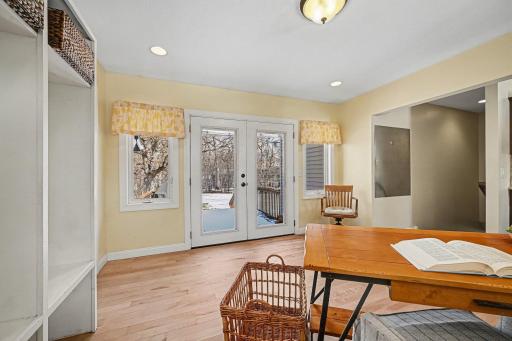 Natural light pours through the glass doors of this spacious mudroom. Step right out to the deck for a BBQ or morning coffee. Ideally situated near the kitchen, making outdoor dining and backyard access a breeze. Pure convenience!