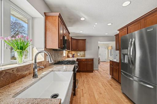 Beautifully updated! White birch hardwood floors, a classic farm sink , and sleek stainless steel appliances. Three windows fill the space with natural light. Features knockdown ceilings, recessed lights, and vast counter space for perfect meal prep.