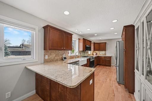 The heart of the home! Granite countertops feature a large peninsula with seating for 2-3 stoolsâperfect for morning coffee. Abundant maple cabinets offer endless storage for all your culinary needs. Bright, functional, and updated!