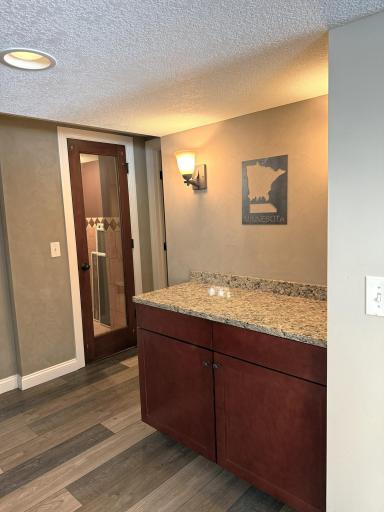 Get ready to entertain! The lower level features a stylish bar area with a granite counter and your very own wine closet with a sleek glass door. The perfect setup for hosting game nights or wine tastings in your private walk-out retreat.