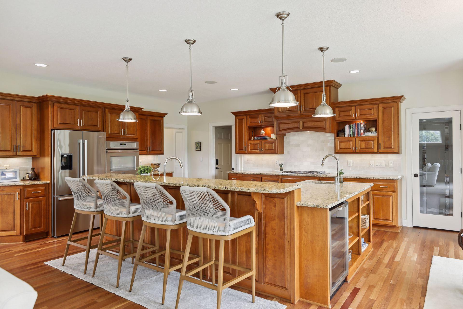 This gourmet kitchen featuring rich cherry cabinetry, granite countertops, a large center island, Brazilian hardwood floors, walk-in pantry, and a beverage fridge for effortless entertaining.