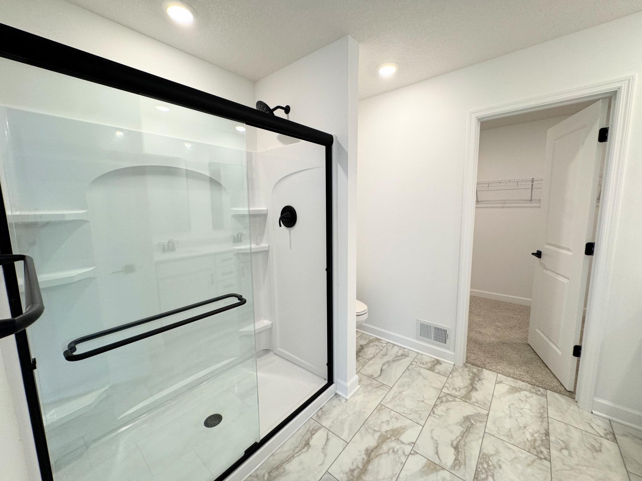 Enjoy direct access to a spa-inspired bathroom from the owner’s suite