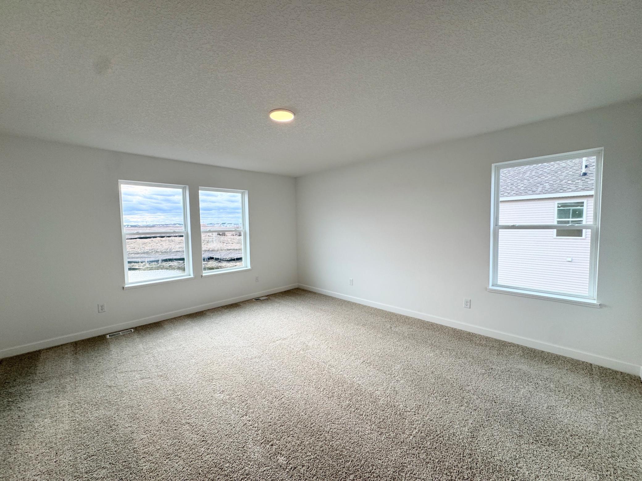 The second-floor owner’s suite is a private sanctuary within the home, complete with a spa-like bathroom and generous walk-in closet.