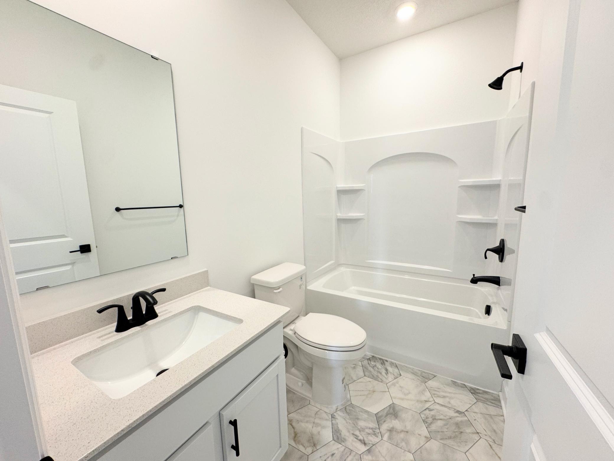 This full bathroom is located on the first level, perfect for daytime and guest use.
