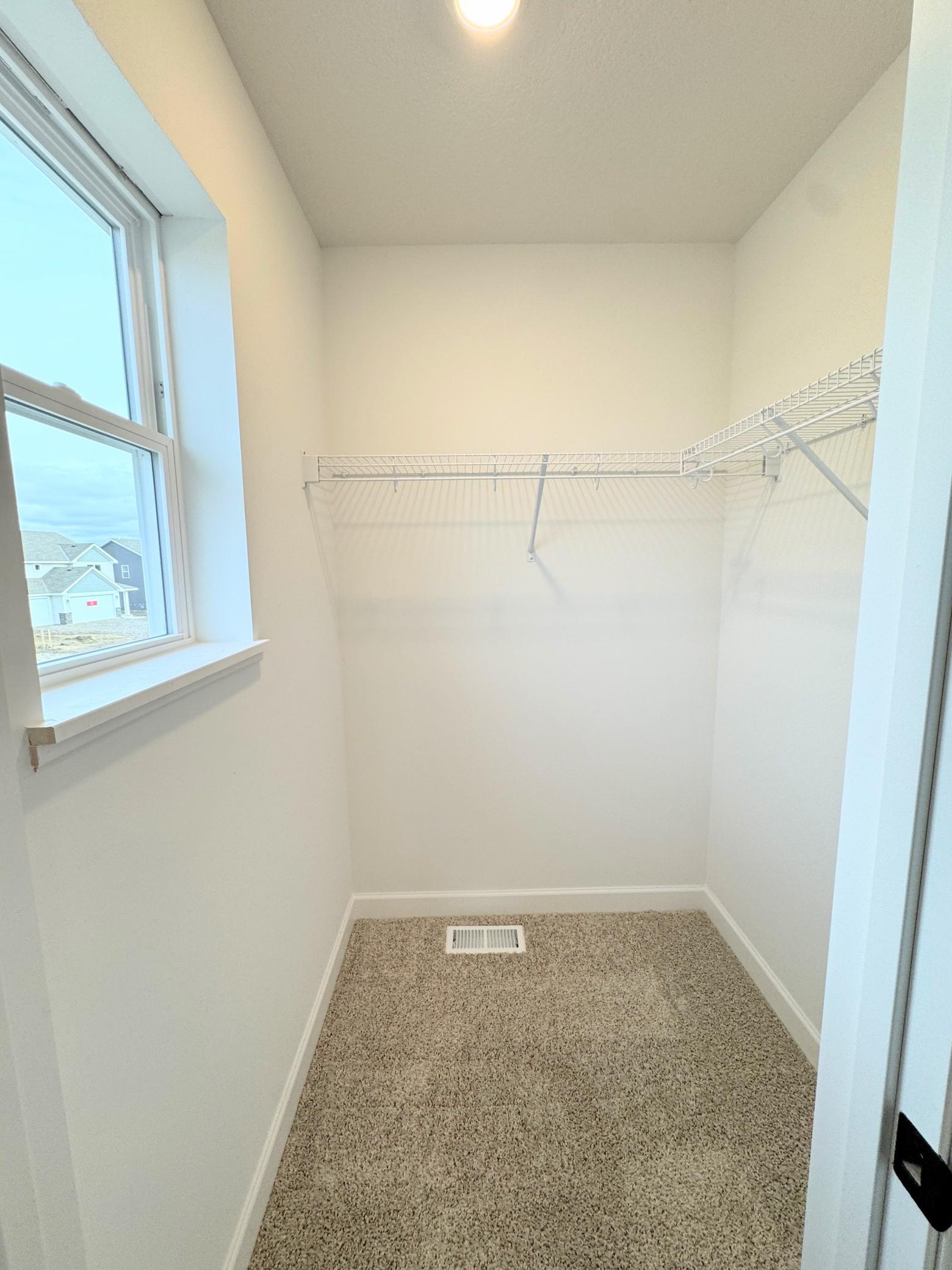 This bedroom features a walk-in closet so residents can easily store clothing and other belongings