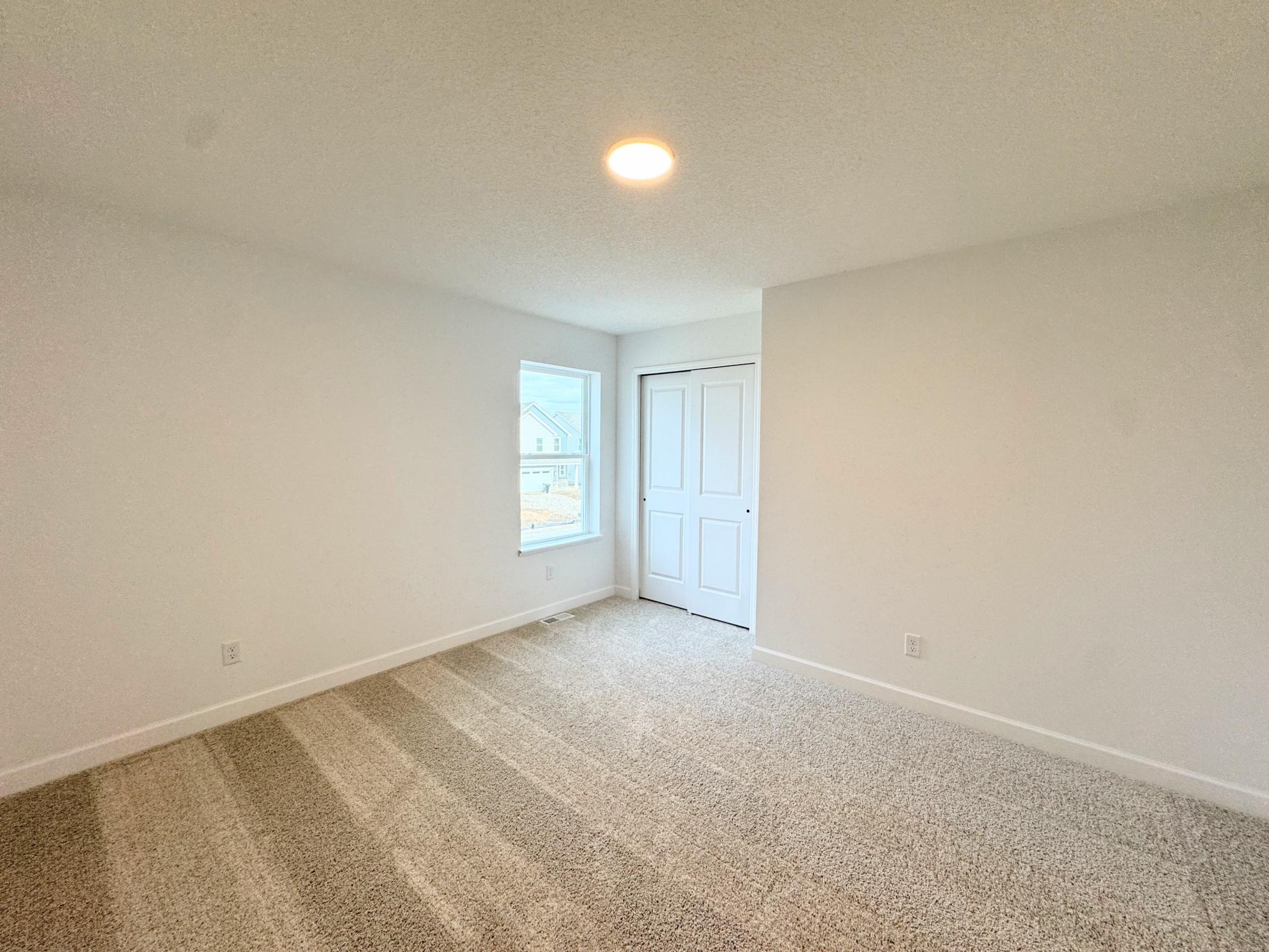 The secondary bedrooms offer comfort and privacy away from the communal spaces found on the first floor.