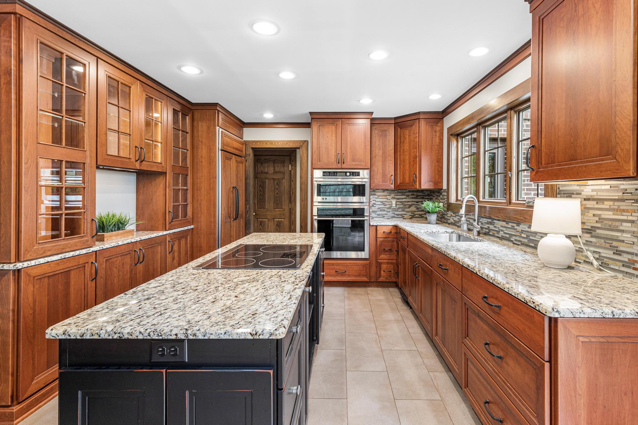 Large center island, granite countertops, custom cabinetry, stainless steel appliances and more.