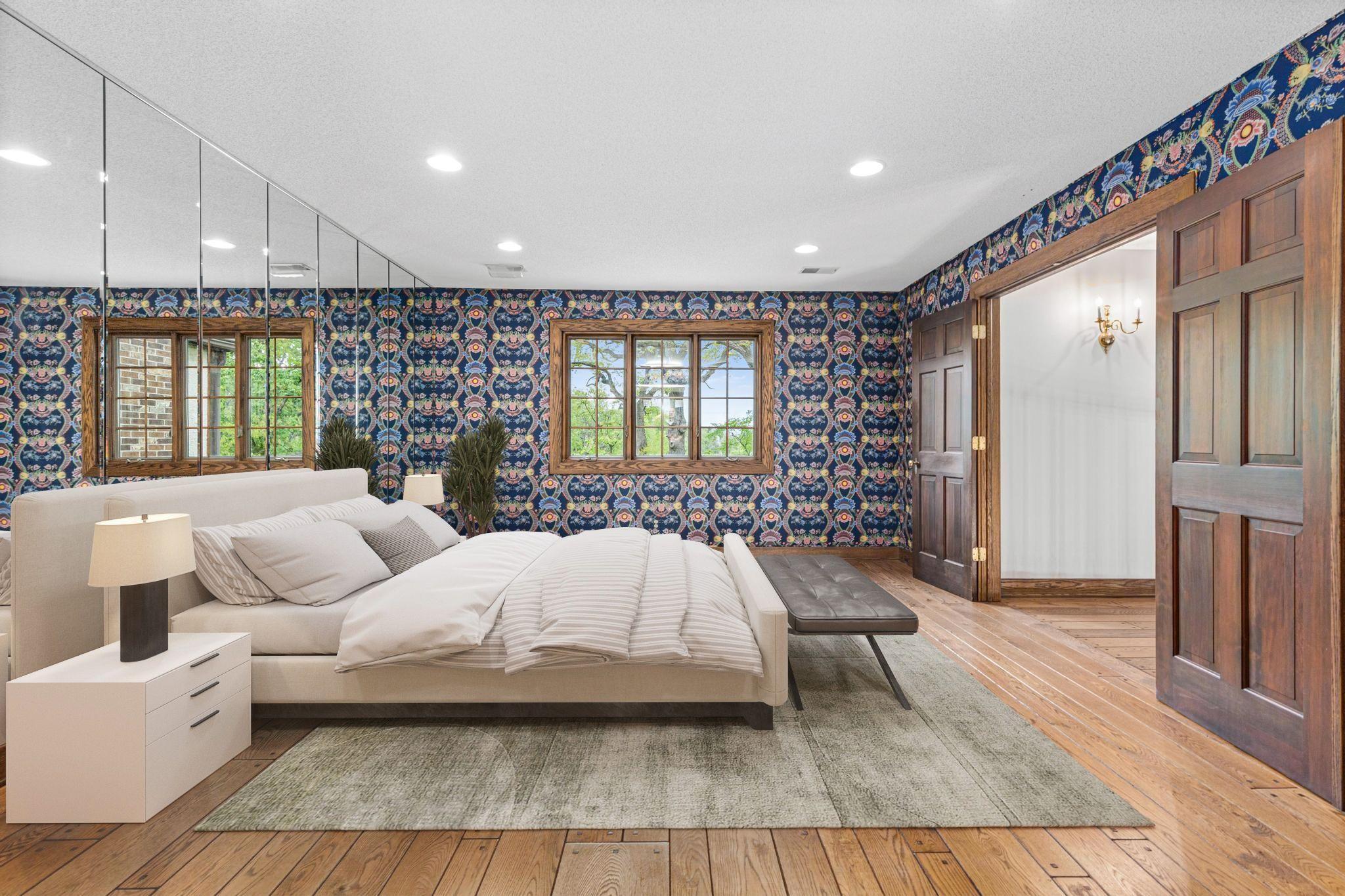 Luxurious primary suite offering serene views and timeless comfort. Cloth wall coverings can be easily removed. Visually staged.