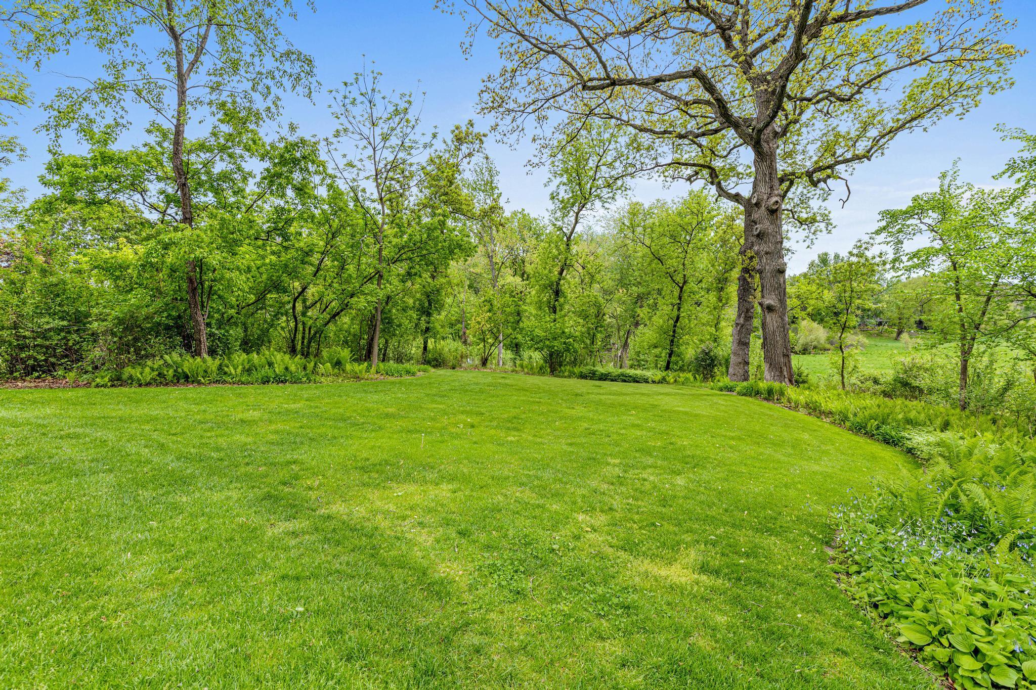 Sweeping meadow views and an unparalleled sense of privacy and tranquility. Impeccably landscaped grounds feature mature trees, lush perennial gardens and multiple outdoor living spaces.