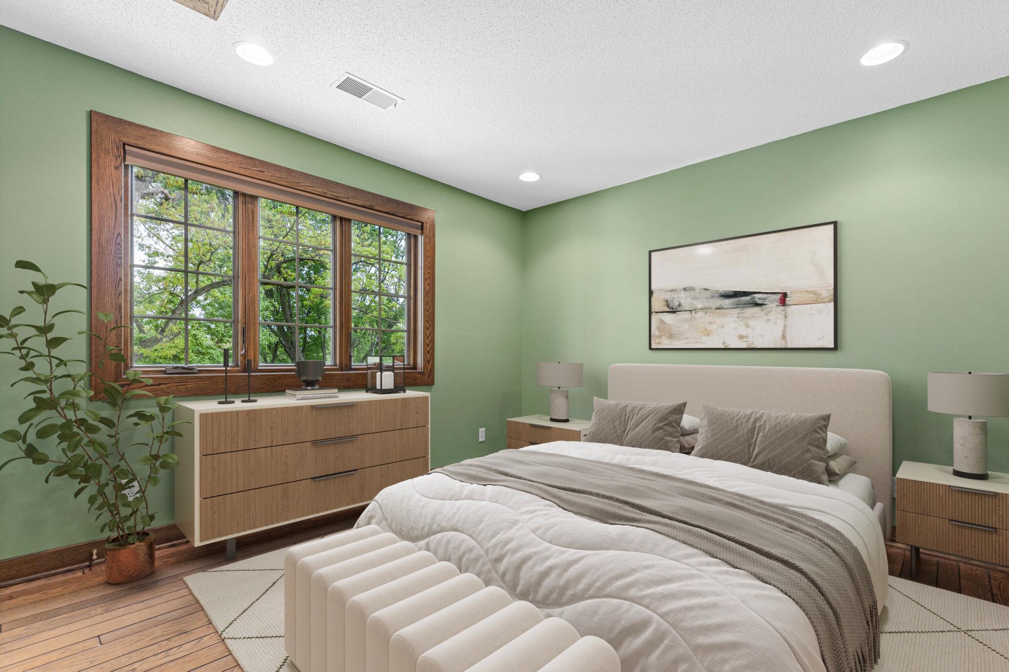 One of four upper level bedrooms with private views to the backyard. Visually staged.