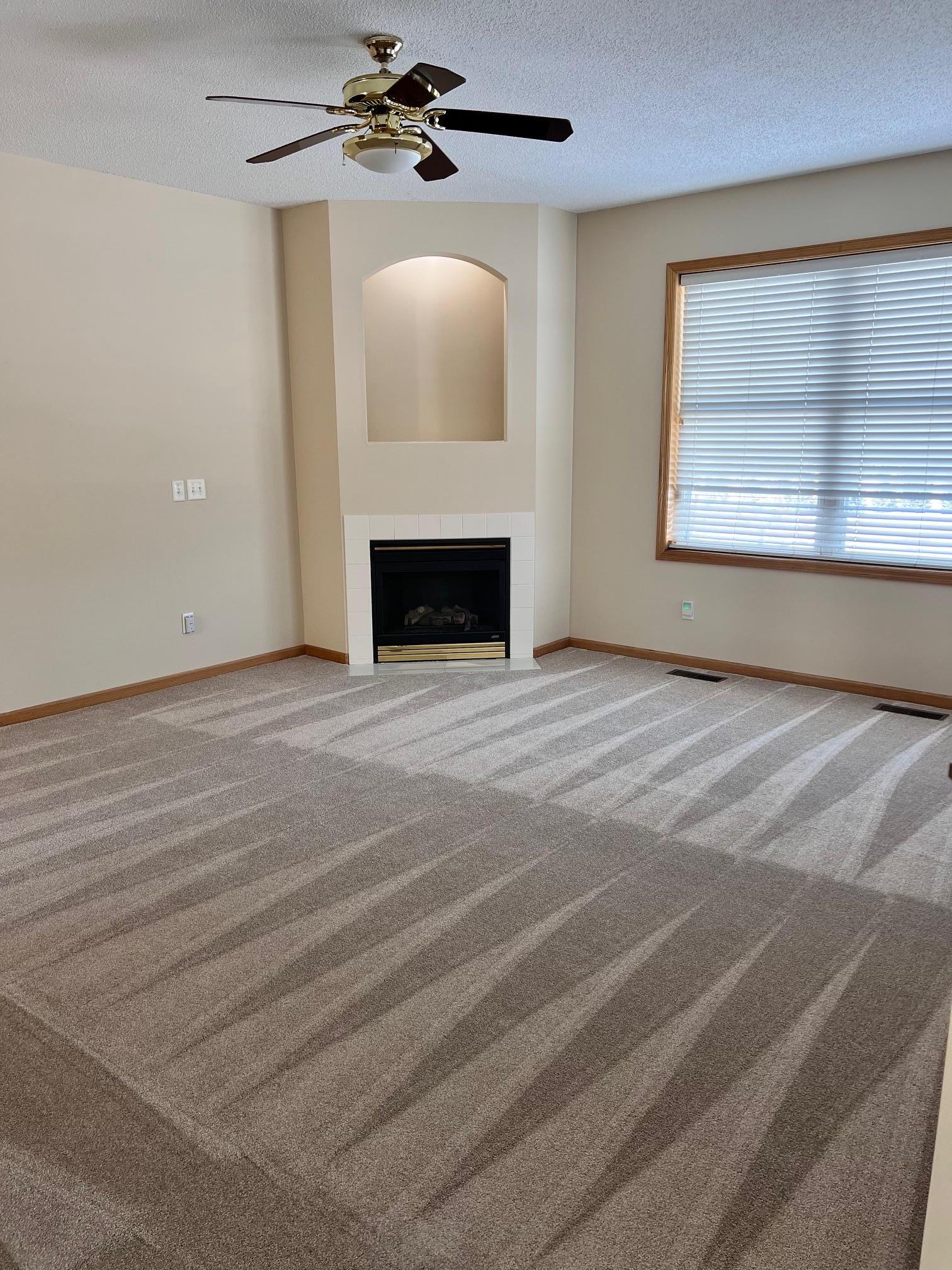 A spacious living room with a gas-burning fireplace sets the tone for comfort and understated luxury.