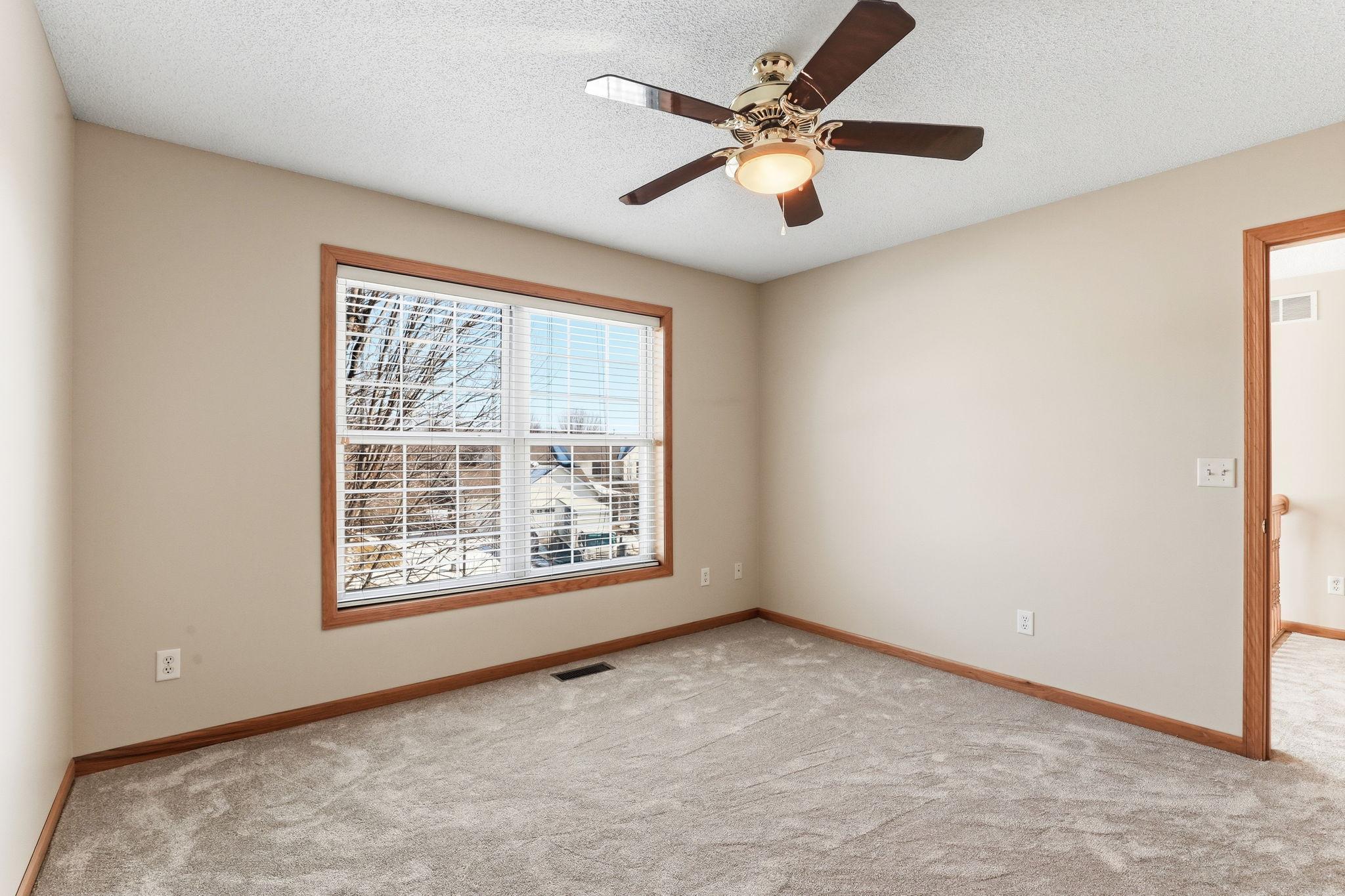 Third upper level bedroom with walk-in closet