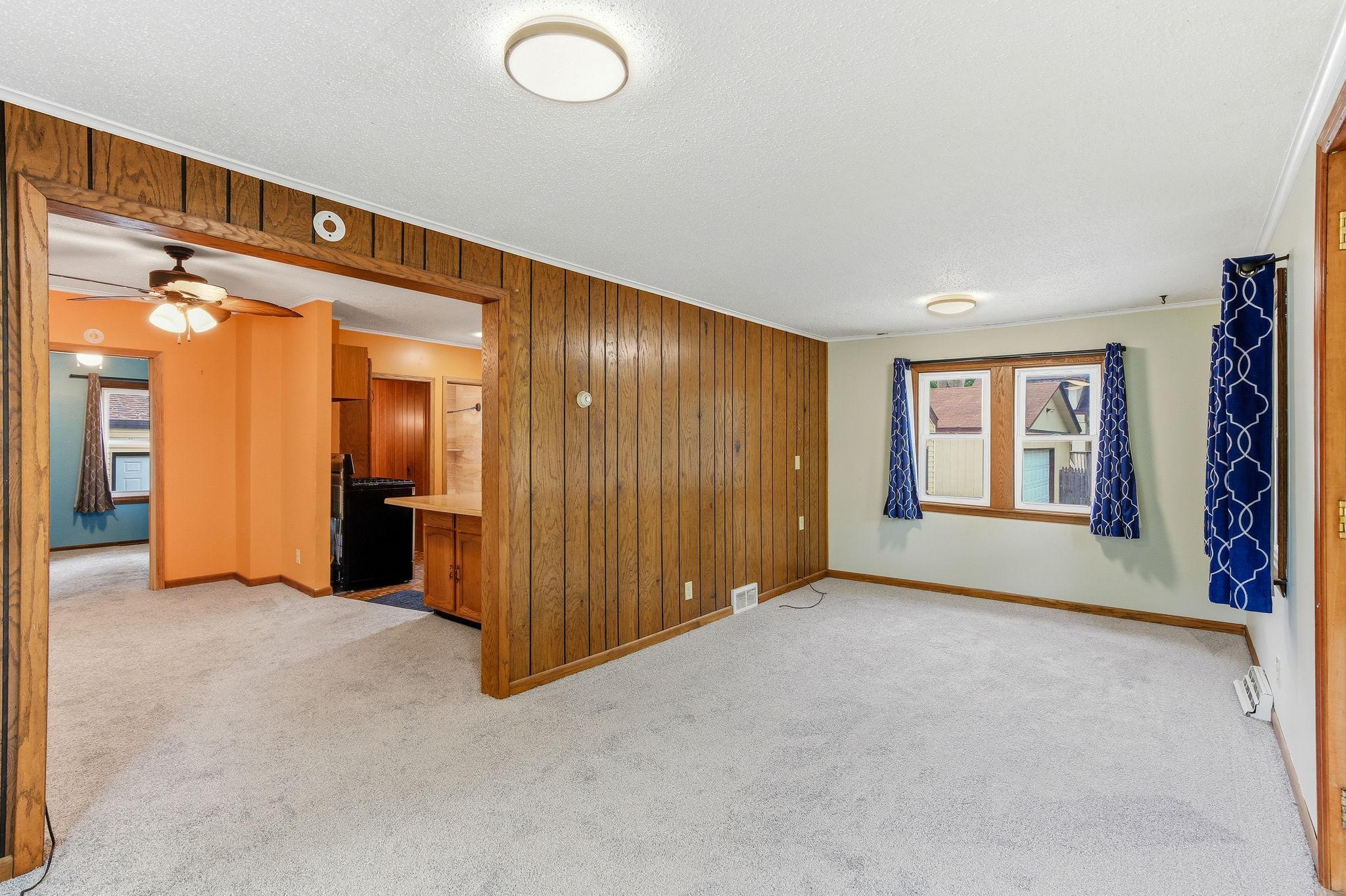 Living room with view of dining room and kitchen to the left.