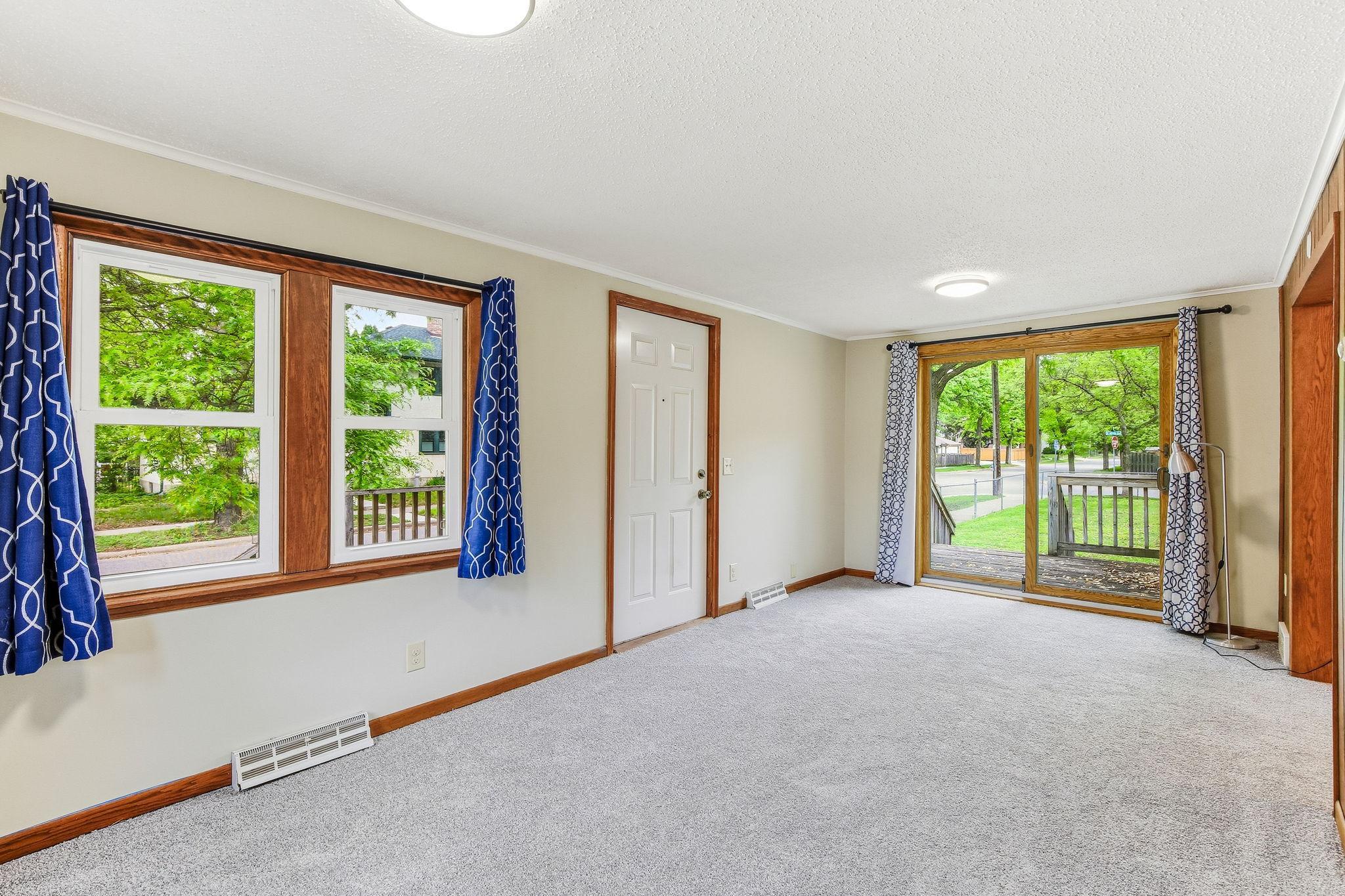 Living room looking towards patio doors and deck. Notice the newer vinyl windows?