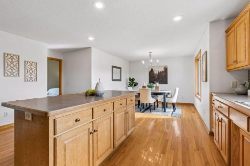 Warm hardwood floors flow from the kitchen into the dining room.
