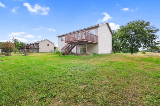 A wider look at the backyard, deck, and open lawn