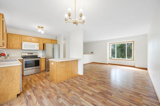 Another look at the open main level, with the kitchen, dining area, and living room all connected in one bright space