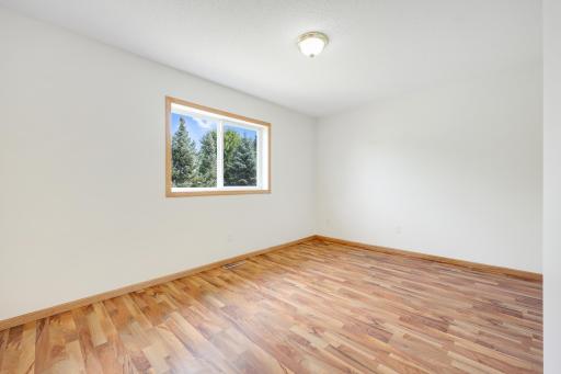 Upper-level bedroom with a large window and natural light