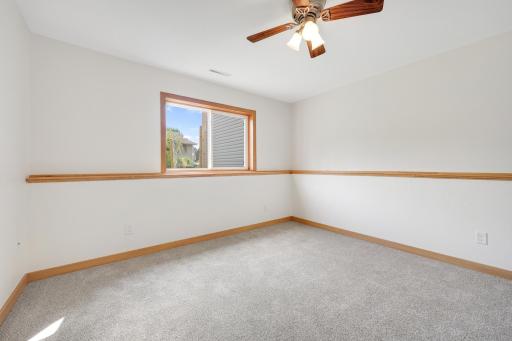 Spacious lower-level bedroom with room for more than just the basics