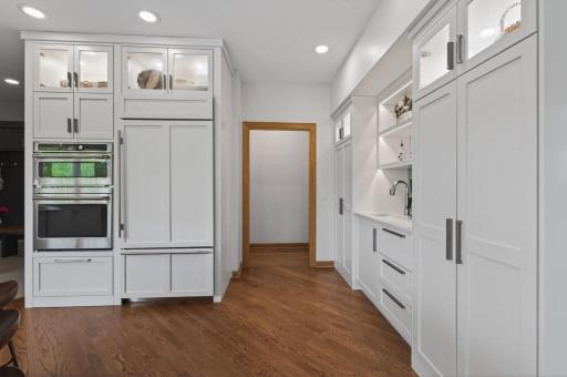 Custom pantry and built-in beverage station with extensive storage and prep space.