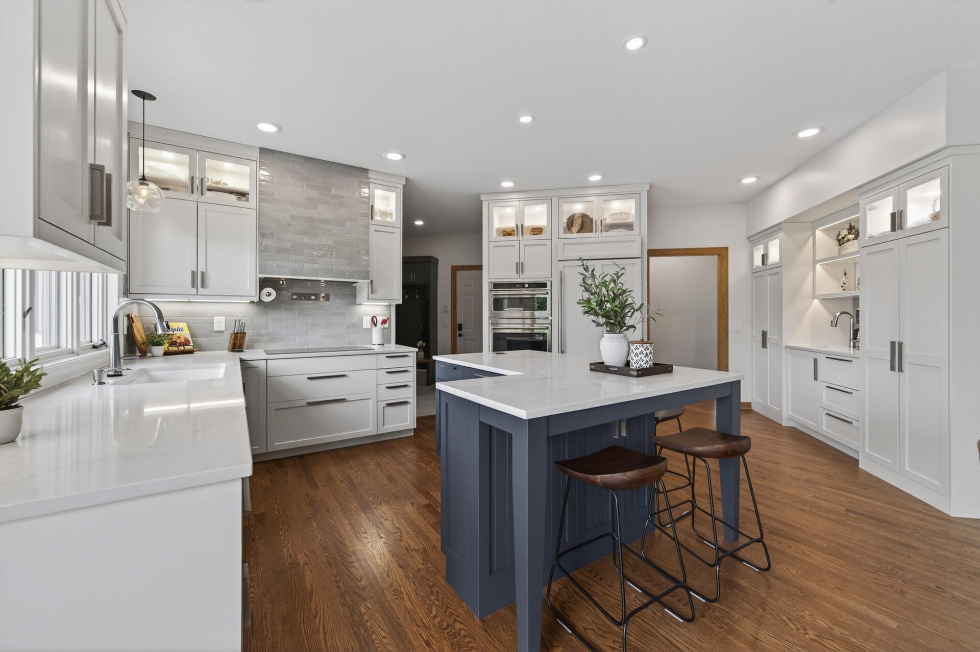 Updated kitchen with quartz countertops, center island, and custom cabinetry.
