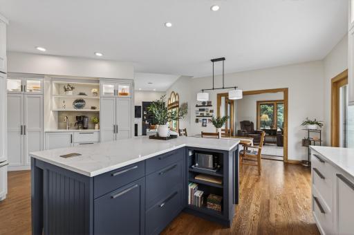 Expansive center island with prep space, storage, and open flow to the dining and living areas.