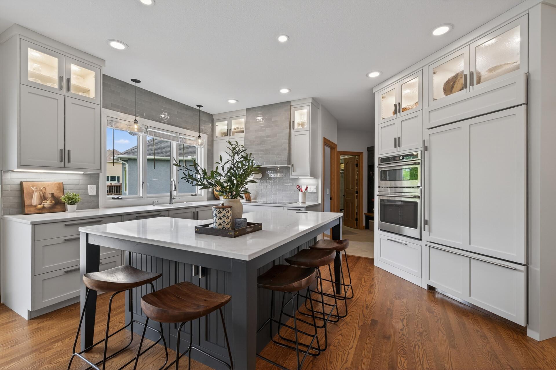 Spacious kitchen with oversized island, double wall ovens, and abundant storage.